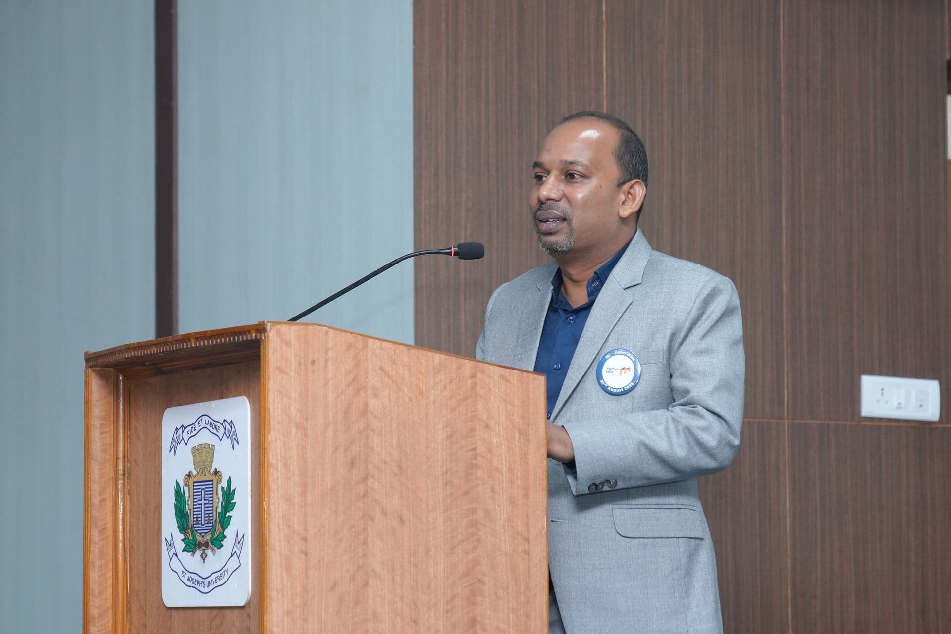 Mr. John Benedict A speaking at a podium