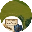 Title deed, key, and shield representing secure land titles